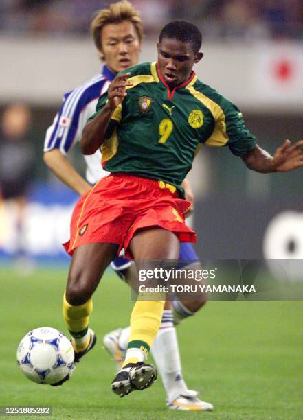 Cameroon forwarder Samuel Etoo shoots the ball before Japanese defender Ryuzo Morioka during the preliminary round match of the FIFA Confederations...