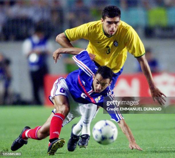 France's Youri Djorkaeff struggles with Brazil's Lucio for the ball during the semi-final of the FIFA's Confederations Cup match between France and...