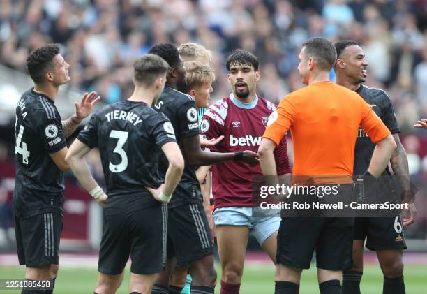 Arsenal players appeal after referee David Coote had awarded West Ham United a penalty during the Premier League match between West Ham United and...