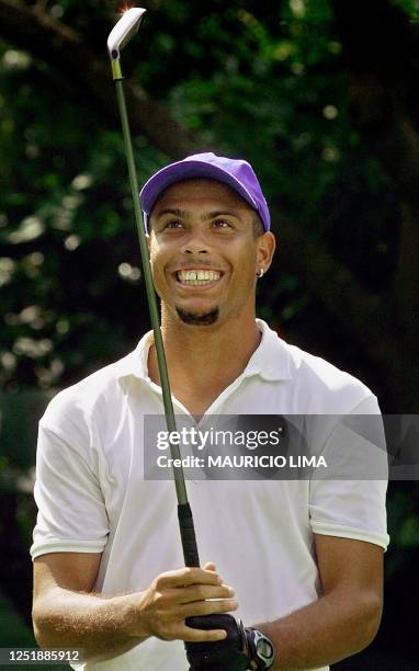 Ronaldo Nazario de Lima, star Brazilian soccer player and player for the Inter de Milan, smiles looking at his golf club during a tournament at the...