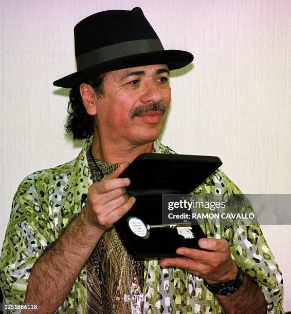 Musician Carlos Santana shows the keys of his hometown Autlan, Jalisco State, Mexico, 27 February 2001, during a ceremony honoring him. Carlos...