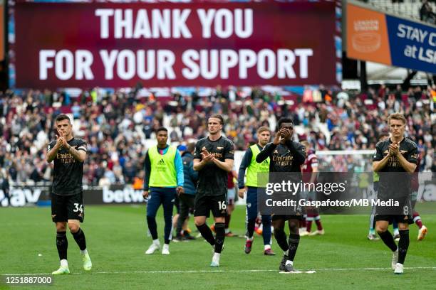 Players of Arsenal applaud the fans after the Premier League match between West Ham United and Arsenal FC at London Stadium on April 16, 2023 in...