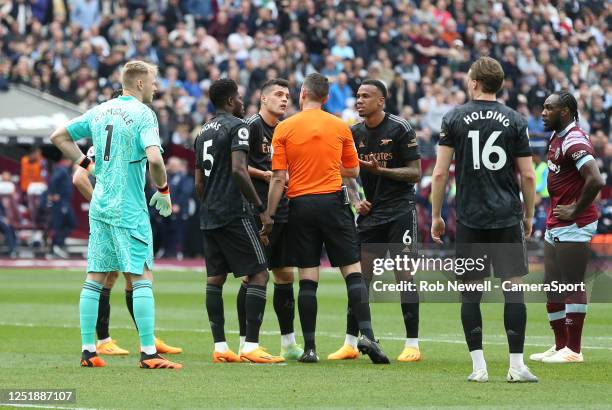 Arsenal players appeal after referee David Coote had awarded West Ham United a penalty during the Premier League match between West Ham United and...