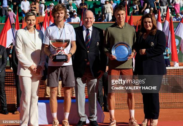 Russia's Andrey Rublev celebrates with his trophy next to Prince Albert II of Monaco , second place Denmark's Holger Rune , Princess Charlene of...