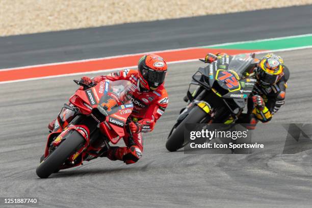 Francesco Bagnaia of Italy and Ducati Lenovo Team and Maverick Vinales of Spain and Aprilia Racing leaving turn 15 during Qualifying Session 2 of the...