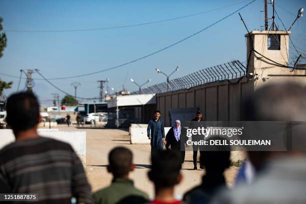 Man, suspected of having collaborated with the Islamic State group, walks accompanied by relatives after being released from the Kurdish-run Alaya...