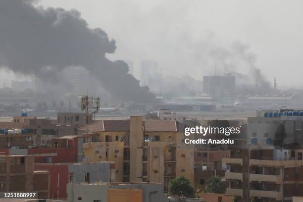 Smoke rises from Khartoum International Airport as clashes continue in the Sudanese capital on April 16, 2023 between the Sudanese Armed Forces and...