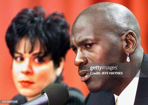 This 13 January, 1999 file photo shows Michael Jordan of the Chicago Bulls, flanked by his wife Juanita, as he addresses a press conference at the...