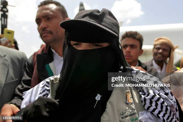 Samira March, whom government forces detained five years ago and accused of organising explosions that killed dozens, gestures upon arrival at Sanaa...