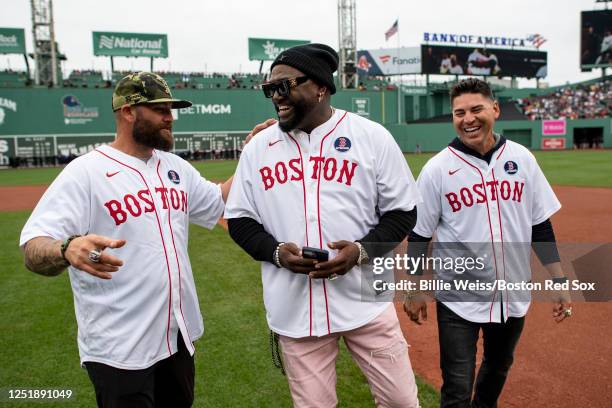 Former Boston Red Sox players Jonny Gomes, David Ortiz, and Jacoby Ellsbury react during a pre-game ceremony in recognition of the 10 year...