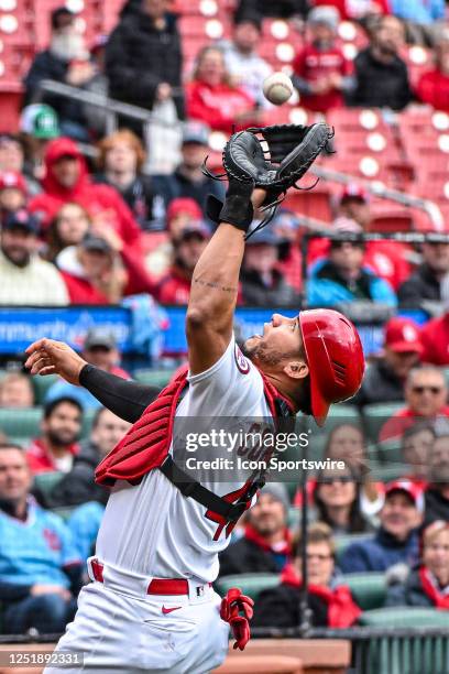 St. Louis Cardinals catcher Willson Contreras catches the popup behind home plate for the final out of the top of the first inning during a game...