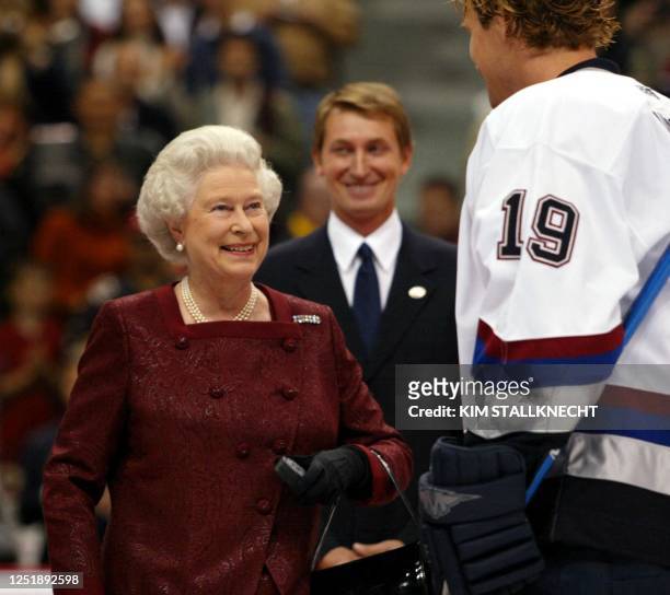 Britain's Queen Elizabeth II talks to Vancouver Canucks captain Markus Naslund following her ceremonial puck drop prior to the Canucks preseason game...