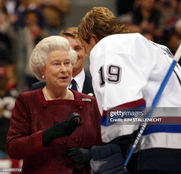 Britain's Queen Elizabeth II talks to Vancouver Canucks captain Markus Naslund following her ceremonial puck drop prior to the Canucks preseason game...