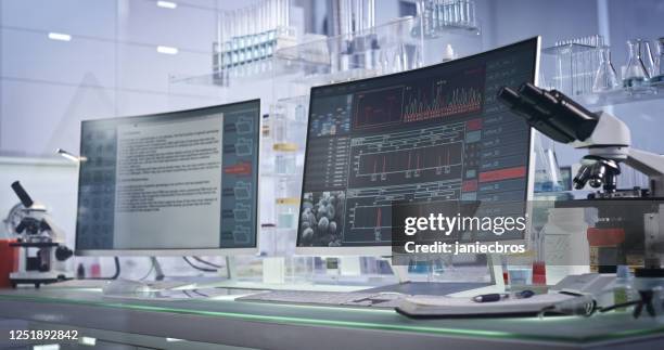 futuristic laboratory equipment. dna research on computer screens - scientific research stock pictures, royalty-free photos & images