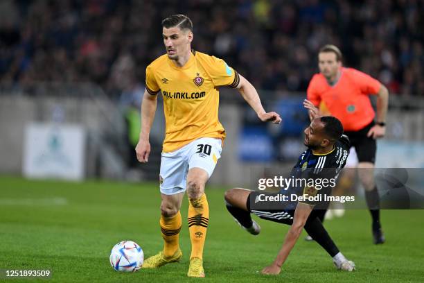 Stefan Kutschke of SG Dynamo Dresden and Bone Uaferro of 1.FC Saarbruecken battle for the ball during the 3. Liga match between 1. FC Saarbrücken and...