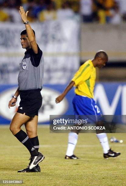 During a friendly game between Brazil and Paraguay, Referee Oscar Ruiz signals the anullment of the goal, while the Brazilian player, Edilson, walks...