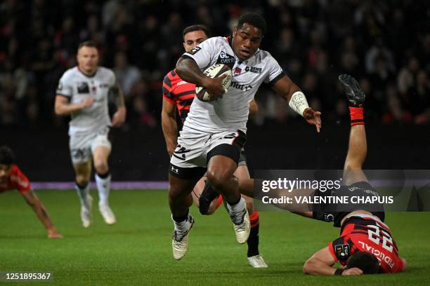 Lyon's Fijian centre Joshua Tuisova runs with the ball during the French Top14 rugby union match between Stade Toulousain Rugby and Lyon Olympique...