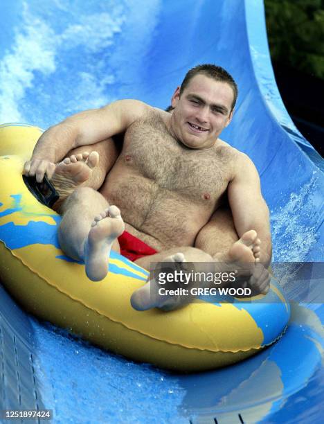 Trevor Woodman, prop with England's Rugby World Cup side, rides the "White Water Mountain" at "Wet n Wild" on the Gold Coast in Queensland, 28...