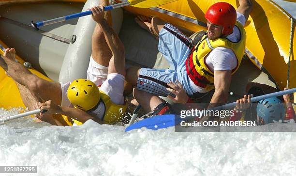 Australian fullback Chris Latham and other teammates capsize while riding the Pacific waves in a raft in Coffs Harbour , 21 October 2003.The...