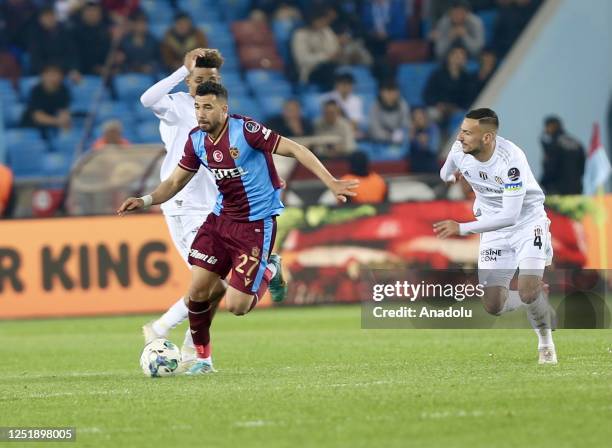 Gedson Fernandes of Besiktas in action against Trezeguet of Trabzonspor during the Turkish Super Lig week 29 football match between Trabzonspor and...