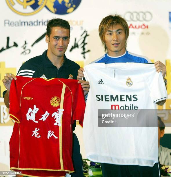 Real Madrid captain Raul exchanges jerseys with Chinese international Li Weifeng who will captain a select Chinese side, 01 August 2003, during a...