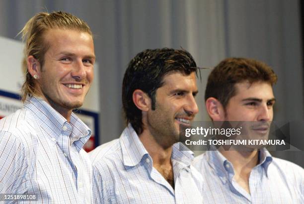 England soccer star David Beckham smiles while posing with his Real Madrid teammates Louis Figo of Portugal and Iker Casillas of Spain at a press...