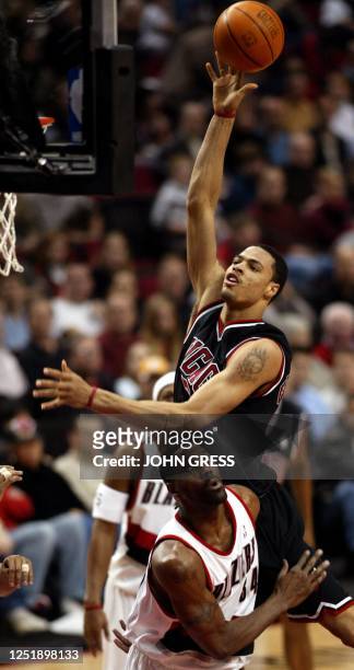 Chicago Bulls' Tyson Chandler shoots over the Portland Trail Blazers' Dale Davis during the first quarter 31 January 2003 in Portland, Oregon. AFP...