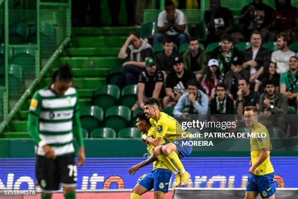 Arouca's Brazilian forward Antony Alves celebrates with teammates after scoring his team's first goal during the Portuguese league football match...