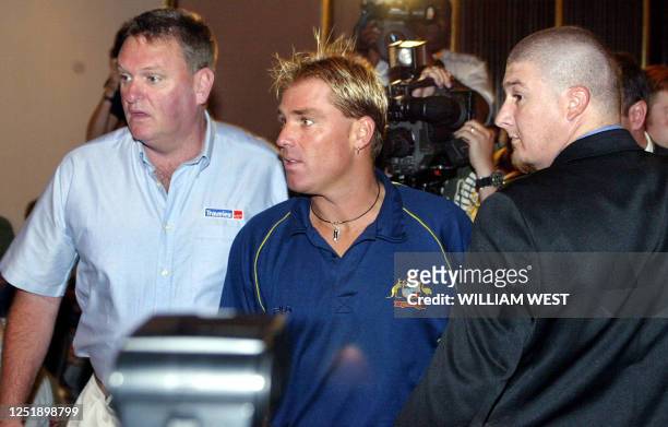 Australian leg spinner Shane Warne is surrounded by heavy security as he attends a press conference announcing he has tested positive to two banned...