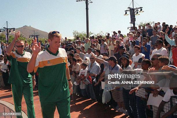 South African cricket captain Shaun Pollock and bowler Allan Donald wave to fans after an autograph session at the Victoria and Alfred Waterfront in...