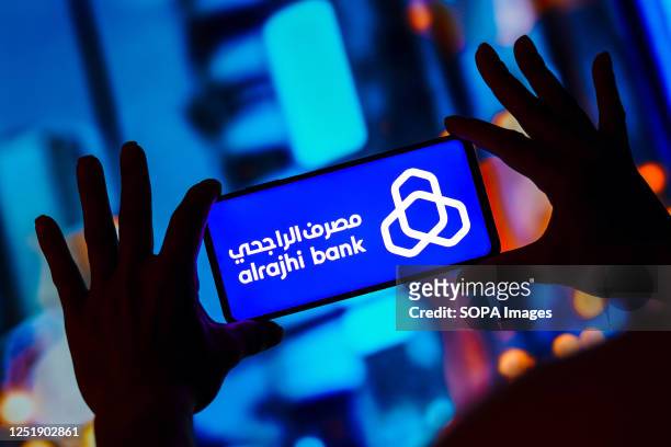 In this photo illustration, the Al-Rajhi Bank logo is displayed on a smartphone screen.