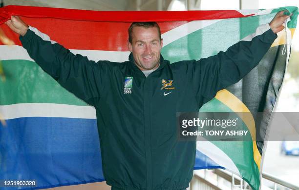 South African Springboks captain Corne Krige proudly displays his national flag from the balcony of his Fremantle hotel as the team prepares for...