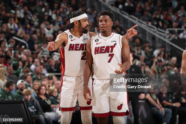 Gabe Vincent and Kyle Lowry of the Miami Heat look on during the game against the Milwaukee Bucks during Round One Game One of the 2023 NBA Playoffs...
