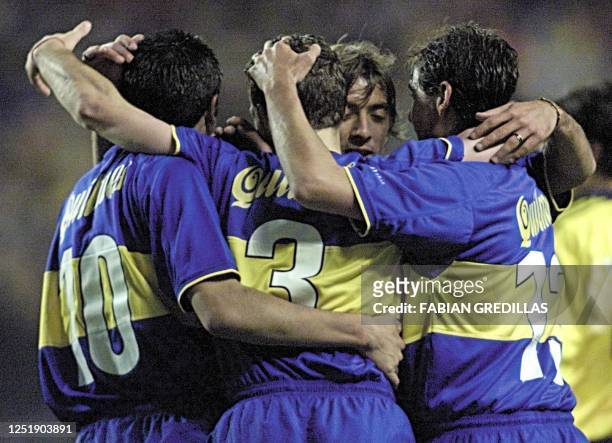 Roman Riquelme , Rodolfo Arruabarrena and Cristian Traverso embrace Julio Marchant after he made the third goal for Boca Juniors 31 May, 2000 during...