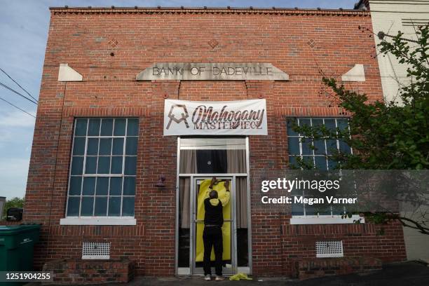 Norman Brooks covers the door of the Mahogany Masterpiece dance studio, the scene of last night's deadly mass shooting, on April 16, 2023 in...