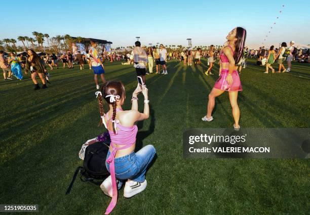 Attendees take photos during the first week-end of the Coachella Valley Music and Arts Festival, in Indio, California, on April 15, 2023.