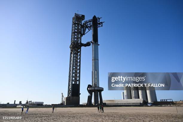 People photograph the SpaceX Starship as it stands on the launch pad ahead of a flight test from Starbase in Boca Chica, Texas on April 16, 2023. -...