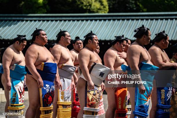 Sumo wrestlers attend the inner courtyard worship after the ceremonial sumo exhibition match "votive grand sumo tournament" at Yasukuni Shrine in...