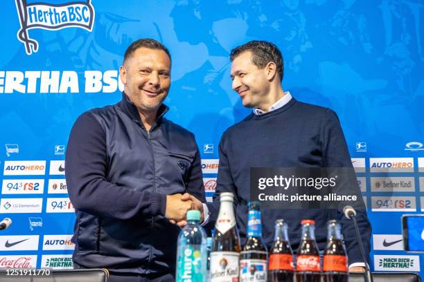 April 2023, Berlin: Soccer, Bundesliga, Hertha BSC, press conference. Newly appointed head coach Pal Dardai and sports director Benjamin Weber shake...
