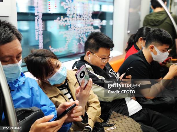 Passengers wearing masks and not wearing masks on Batong subway line in Beijing, April 17, 2023. On Tuesday, the first working day after Beijing...