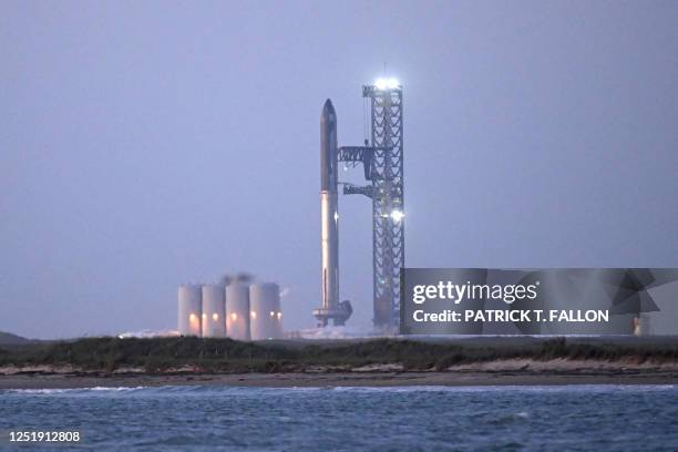 The SpaceX Starship rocket stands on the launchpad ahead of its scheduled launch from the SpaceX Starbase in Boca Chica as seen from South Padre...