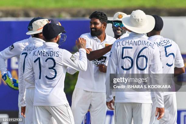 Sri Lanka's Prabath Jayasuriya celebrates with teammates after taking the wicket of Ireland's Curtis Campher during the second day of the first...