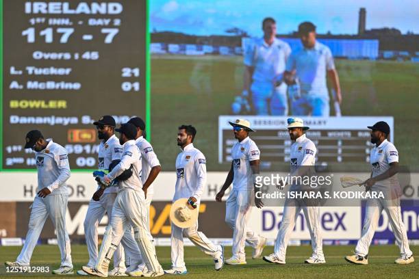 Sri Lanka's players walk back to the pavilion at the end of the second day play of the first cricket Test match between Sri Lanka and Ireland at the...