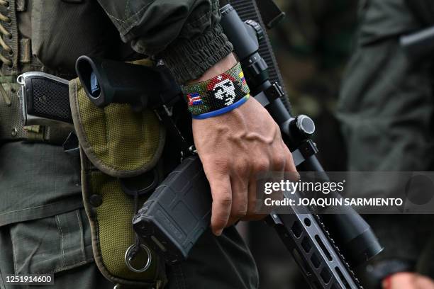 Dissident wears a bracelet with an image of Argentine revolutionary leader Ernesto "Che" Guevara as he attends a meeting with local communities in...