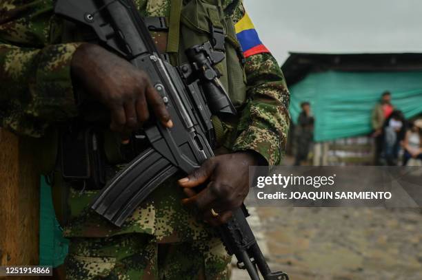 Dissident stands guard during a meeting with local communities in San Vicente del Caguan, Caqueta department, Colombia, on April 16, 2023. - An armed...