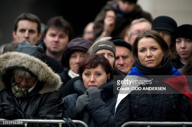 People watch the funeral service of former Czech President Vaclav Havel on giant TV screens at Prague Castle in Prague on December 23, 2011. Havel, a...
