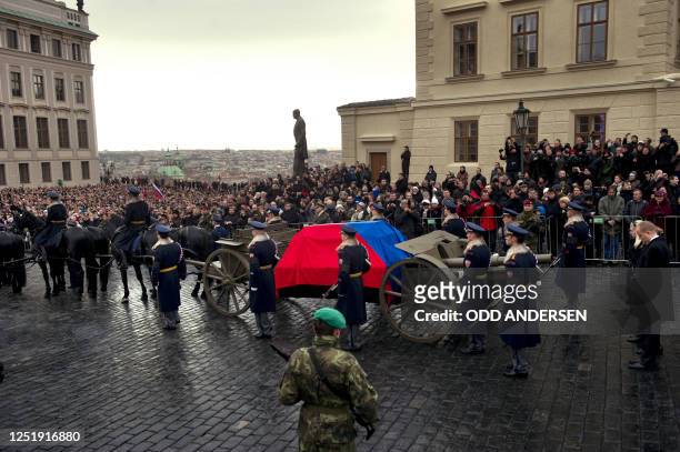 The horse drawn hearse carrying the flag draped coffin of former Czech president Vaclav Havel arrives at the Castle in Prague on December 21, 2011....