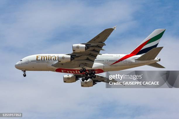 An Emirates Airlines Airbus A380 aircraft descends on its landing approach to Dubai International Airport in Dubai on April 17, 2023.