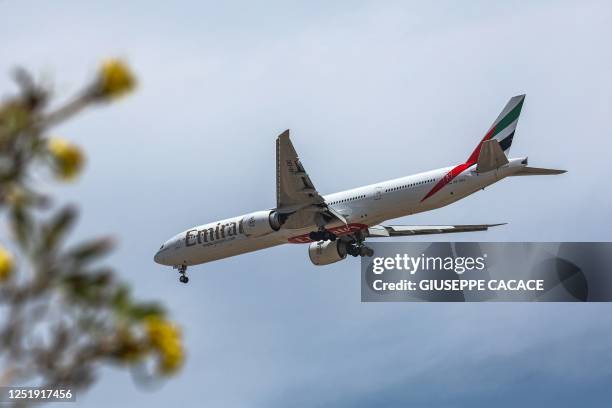 An Emirates Airlines Boeing 777-300 aircraft descends on its landing approach to Dubai International Airport in Dubai on April 17, 2023.