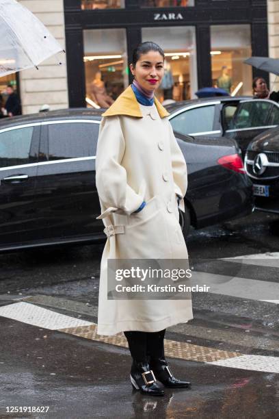 Magazine publisher, fashion director and editor-in-chief of Tank Magazine Caroline Issa wears a Lanvin coat, Roger Vivier boots and a John Smedley...